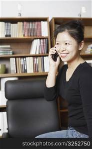 Close-up of a businesswoman using a mobile phone and smiling