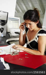 Close-up of a businesswoman using a mobile phone in an office