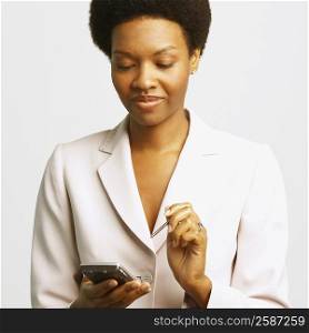 Close-up of a businesswoman using a personal data assistant