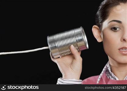 Close-up of a businesswoman using a tin can phone