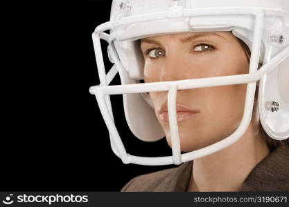 Close-up of a businesswoman wearing a football helmet