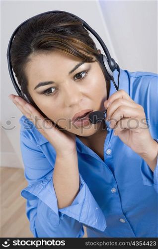 Close-up of a businesswoman wearing a headset and looking away