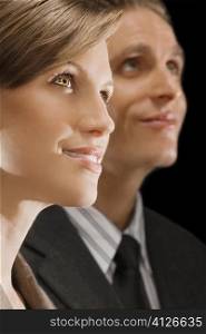 Close-up of a businesswoman with a businessman day dreaming