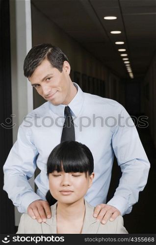 Close-up of a businesswoman with a businessman standing beside her