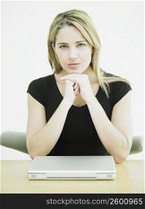 Close-up of a businesswoman with a laptop on the desk