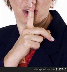 Close-up of a businesswoman with her finger on her lips