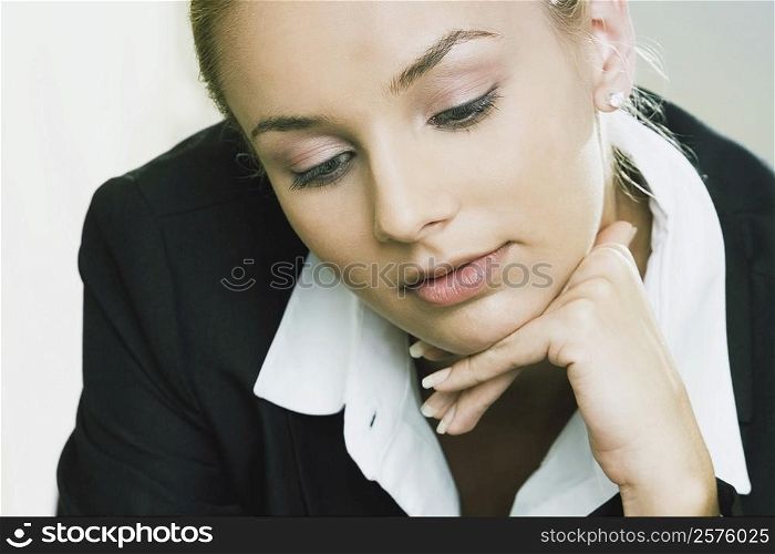 Close-up of a businesswoman with her hand on her chin