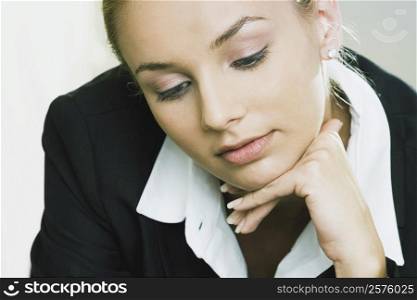 Close-up of a businesswoman with her hand on her chin