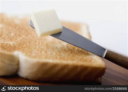 Close-up of a butter knife on bread