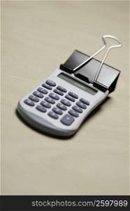 Close-up of a calculator and a paper clip