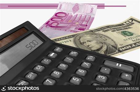 Close-up of a calculator near a five hundred Euro bank note and an American ten dollar bill