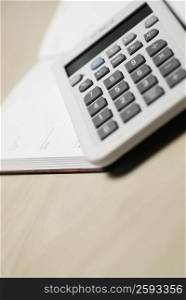 Close-up of a calculator on a diary