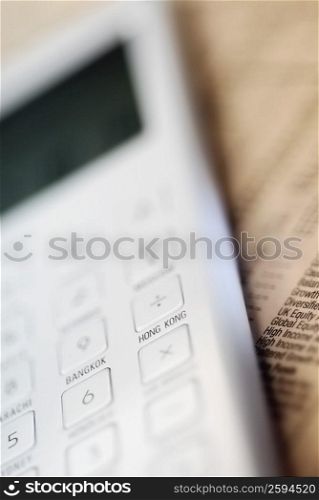 Close-up of a calculator on a financial newspaper