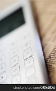 Close-up of a calculator on a financial newspaper