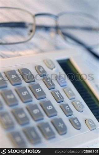 Close-up of a calculator with a pair of eyeglasses