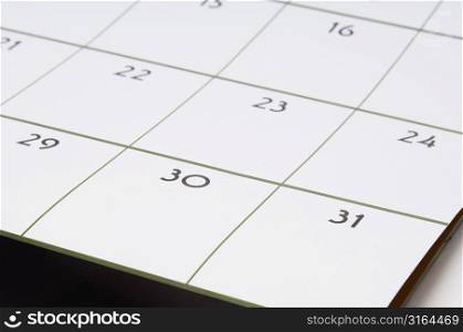 Close-up of a calendar with dates 30 and 31 in focus
