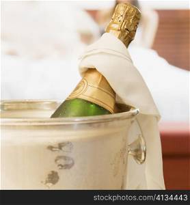 Close-up of a champagne bottle in an ice bucket
