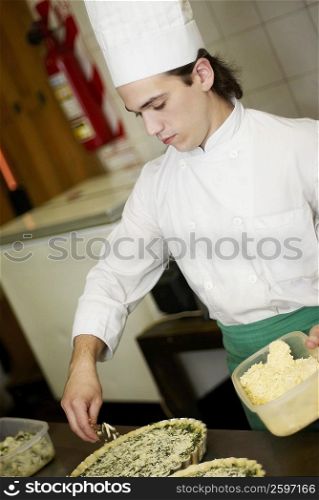 Close-up of a chef preparing food in a commercial kitchen