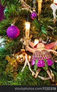 Close-up of a Christmas Tree decorated in a purple theme.