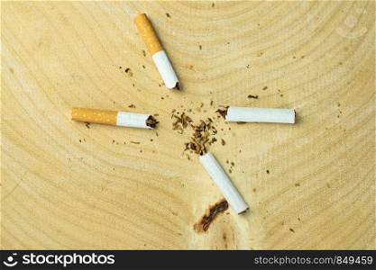 Close up of a cigarette showing on desk wood