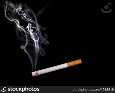 Close up of a cigarette with smoke showing at black background
