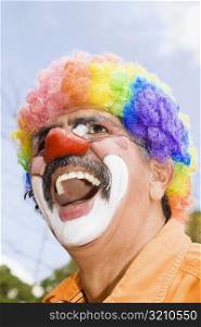 Close-up of a circus clown with a red nose and laughing