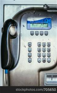 Close up of a classical old fashioned public pay phone