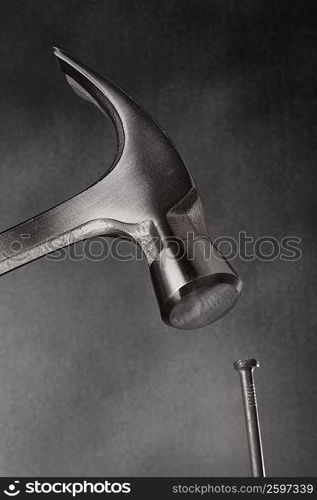 Close-up of a claw hammer hitting a nail