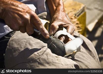Close-up of a cobbler repairing a shoe, HohHot, Inner Mongolia, China