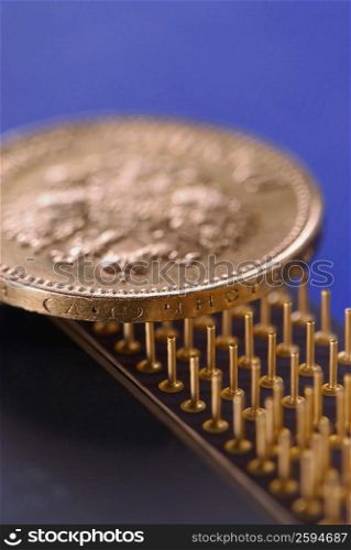 Close-up of a coin on a computer chip
