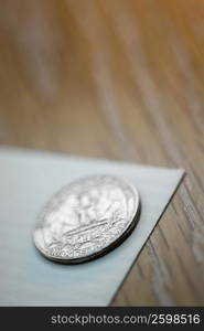 Close-up of a coin on a sheet of paper