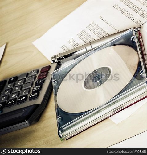 Close-up of a compact disk with a calculator