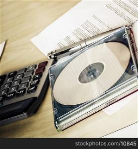 Close-up of a compact disk with a calculator