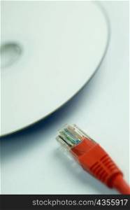 Close-up of a computer cable with a cd