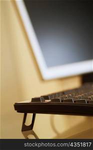 Close-up of a computer keyboard and a computer monitor