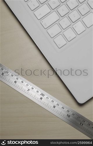 Close-up of a computer keyboard with a ruler