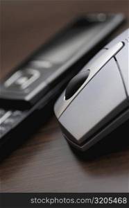 Close-up of a computer mouse with a mobile phone