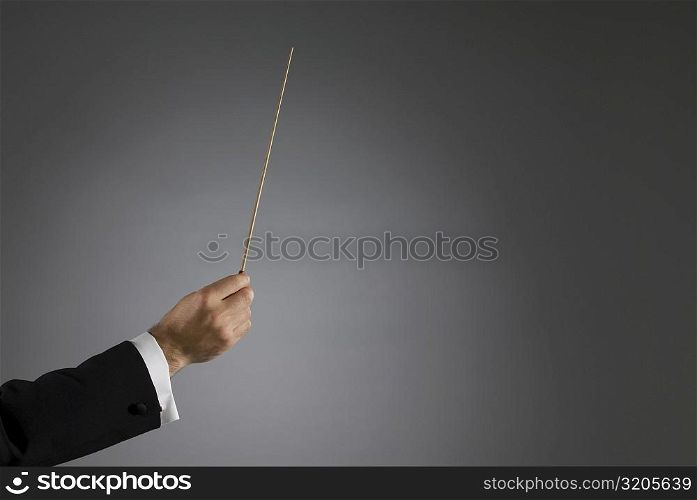 Close-up of a conductor&acute;s hand holding a conductor&acute;s baton