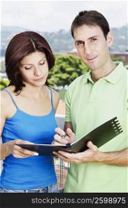 Close-up of a couple holding a file