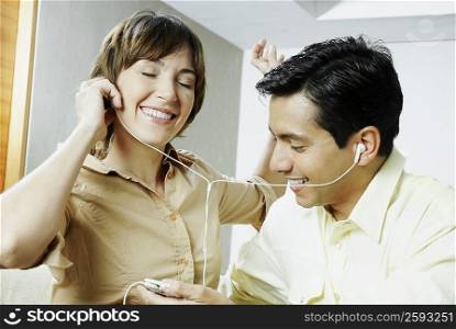 Close-up of a couple listening to music