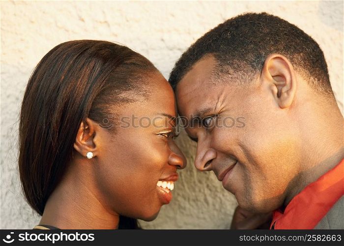 Close-up of a couple looking at each other and smiling