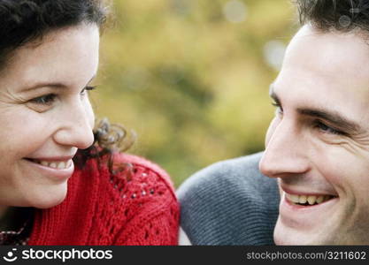 Close-up of a couple looking at each other and smiling