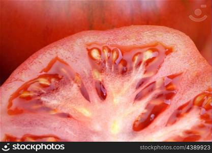 Close-up of a cracked tomato tomatoes surrounded by many with shallow depth of field
