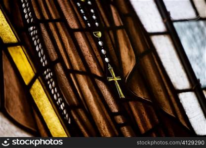 Close-up of a cross on a stained glass window