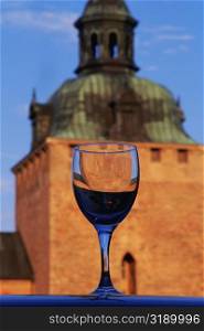 Close-up of a crystal glass with a castle in the background, Kalmar castle, Smaland, Sweden
