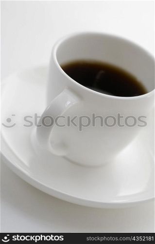 Close-up of a cup of black tea on a saucer