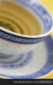 Close-up of a cup of herbal tea on a saucer