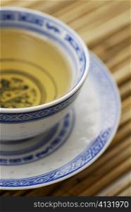 Close-up of a cup of herbal tea on a saucer