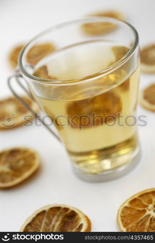 Close-up of a cup of herbal tea with lemon slices