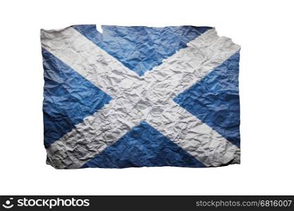 Close up of a curled paper on white background, print of the flag of Scotland